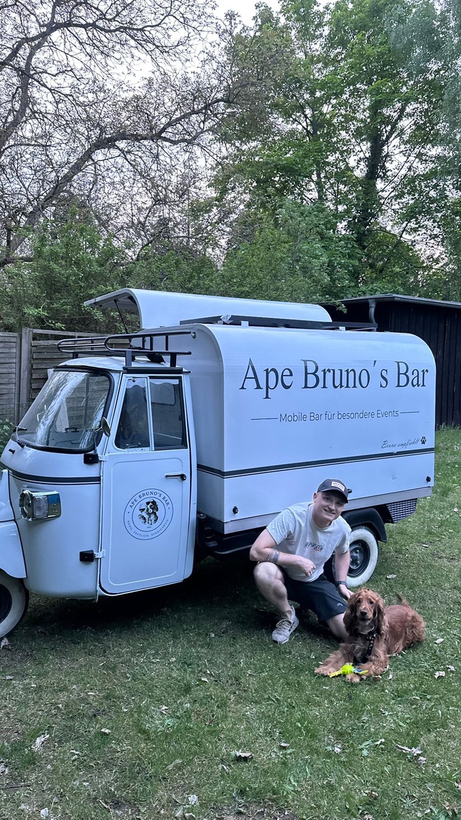 Inhaber Yuri mit Hund Bruno vor der mobilen Bar